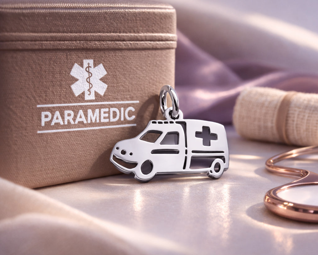 Belle Fever silver ambulance charm for keyring leaning on paramedic box, healthcare worker thank you gift.
