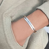 Belle Fever bar cord bracelet styled on wrist, custom engraved name or coordinates bracelet, adjustable unisex keepsake jewelry.