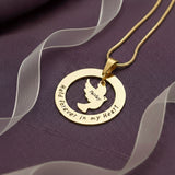 Belle Fever held forever necklace in gold, custom engraved pendant, sympathy gift jewelry on neutral plate background