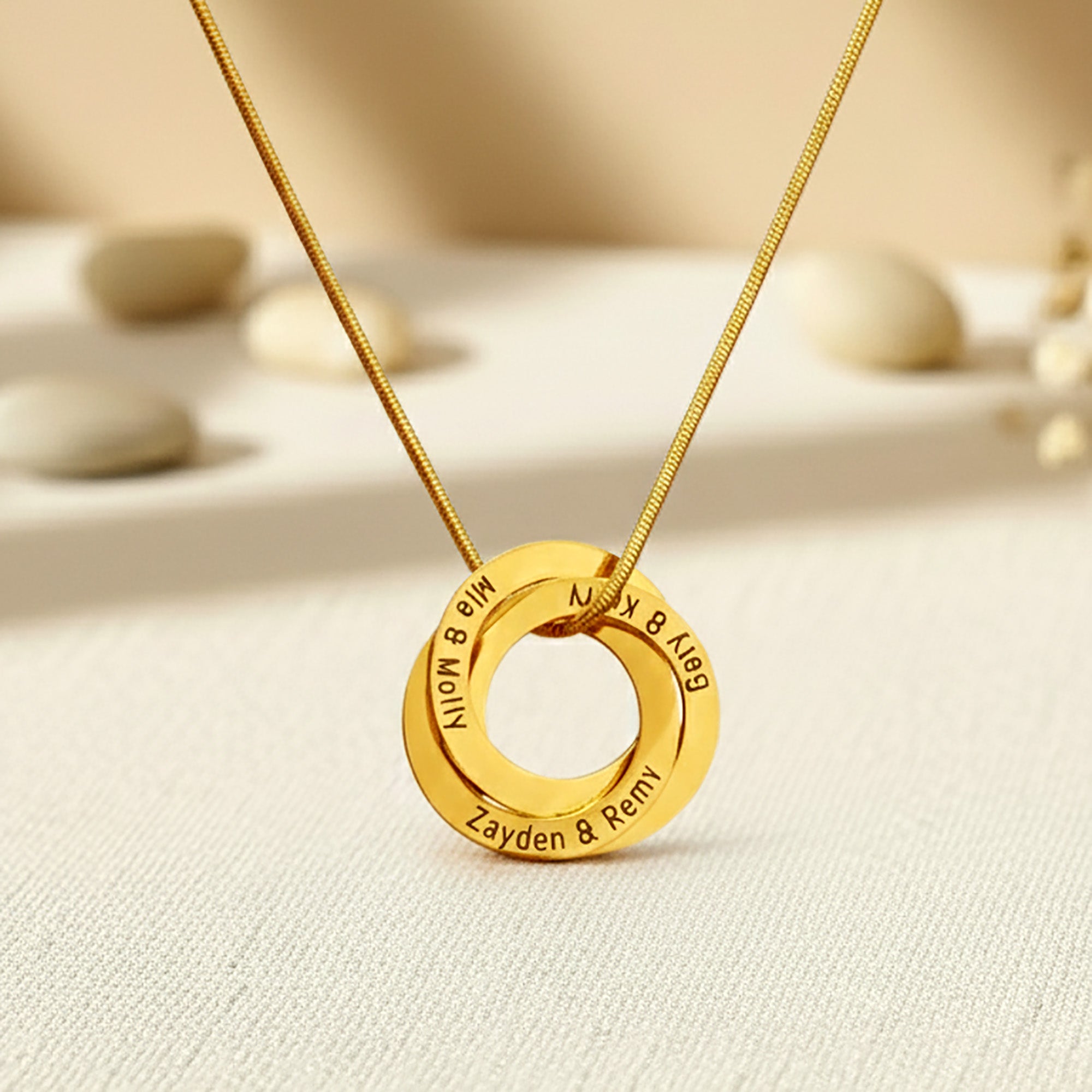Belle Fever Interlinked Family Love Circles Necklace gold personalised circles engraved with family names, styled on a soft neutral background, symbolising unbreakable family bonds.