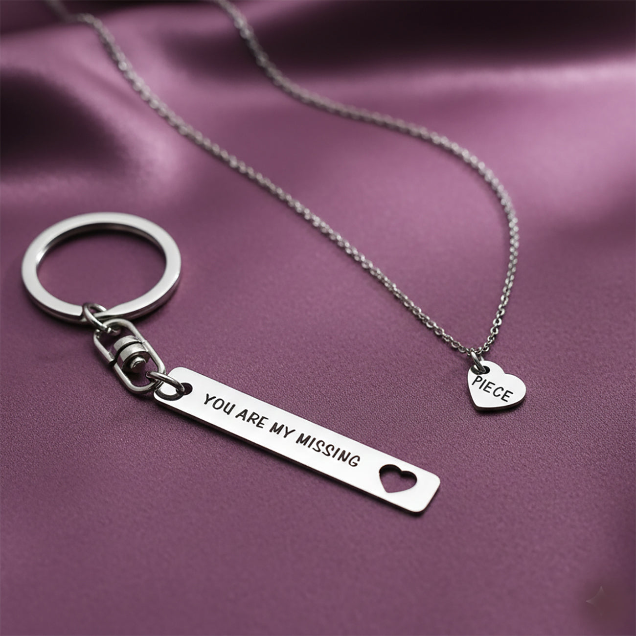 Belle Fever missing piece jewellery set styled on soft purple fabric, couple anniversary gift, romantic everyday necklace and keychain keepsake