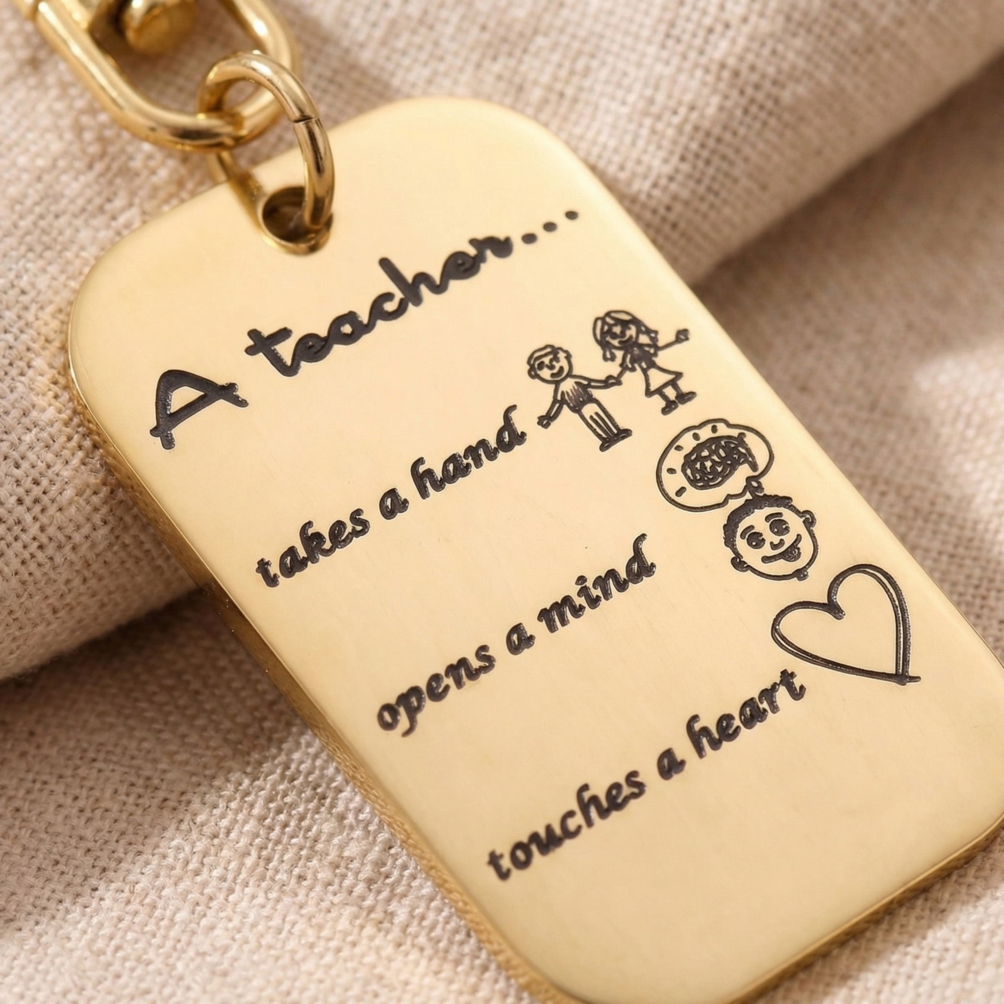 Close-up of personalised dog tag keyring with engraved message and detailed text design