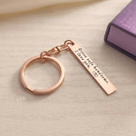 Belle Fever rose gold engraved reminder tag keychain resting on desk, custom bar keepsake gift designed for daily use