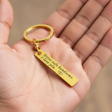 Belle Fever engraved reminder tag keychain held in hand, gold bar keepsake with personal message, sentimental gift for loved one