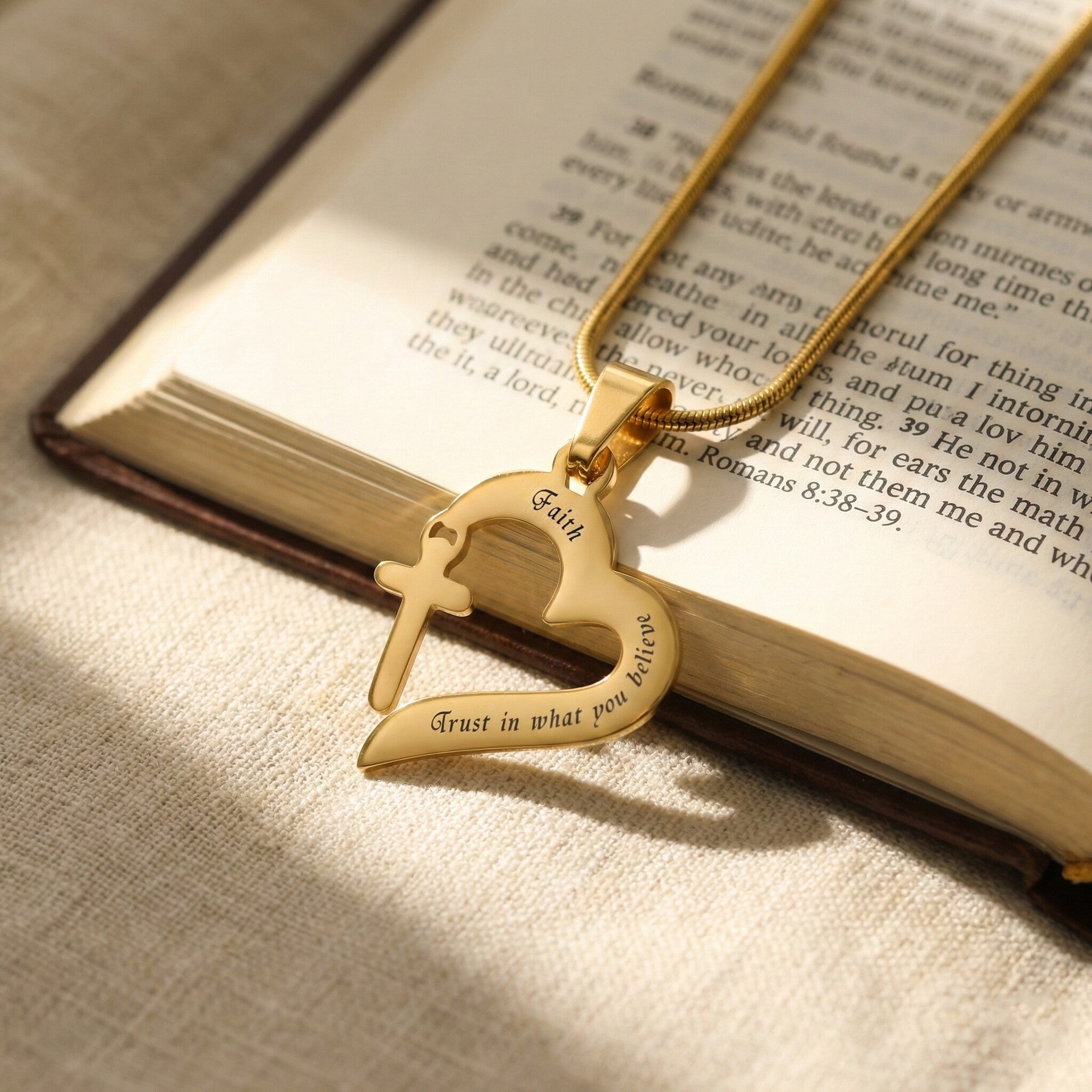 Trust in Him necklace by belle fever styled on book, inspirational Christian necklace with cross heart pendant