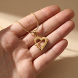 Hand holding Trust in Him necklace by belle fever, faith-based Christian jewelry gift symbolizing trust, hope, and love