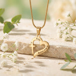 Trust in Him necklace by belle fever displayed on natural background, Christian cross heart necklace symbolizing faith, trust in God, and spiritual devotion