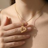 Woman holding Trust in Him necklace by belle fever, meaningful Christian faith jewelry reminding to trust God always