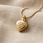 Always Love cremation necklace with gold heart urn pendant on delicate chain displayed on soft neutral fabric