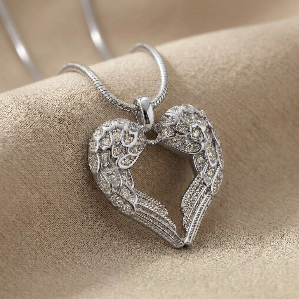 Angels Heart necklace in silver featuring heart shaped angel wings pendant with stone accents