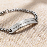 Silver bar bracelet featuring engraved plate detail