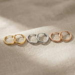 Chic sleeper hoop earrings in gold, silver and rose gold finishes with minimal hoop design