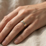 Woman wearing classic band ring in gold, minimalist everyday jewellery lifestyle image