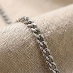Close up of curb chain necklace showing flat interlocking link detail