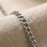 Close up of curb chain necklace showing flat interlocking link detail