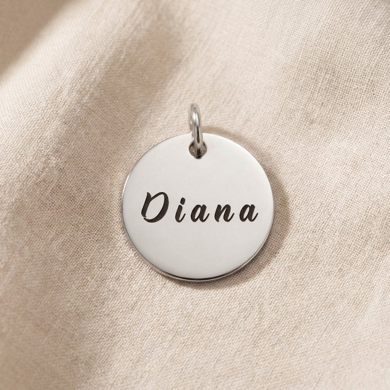 Personalized engraved disc charm for keyring with custom name design and sentimental everyday keepsake