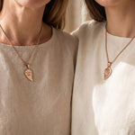 Couple wearing Double Heart Puzzle Necklace set with matching heart pendants, meaningful relationship jewellery