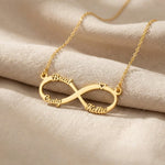Gold infinity name necklace with custom name on infinity pendant displayed on neutral background