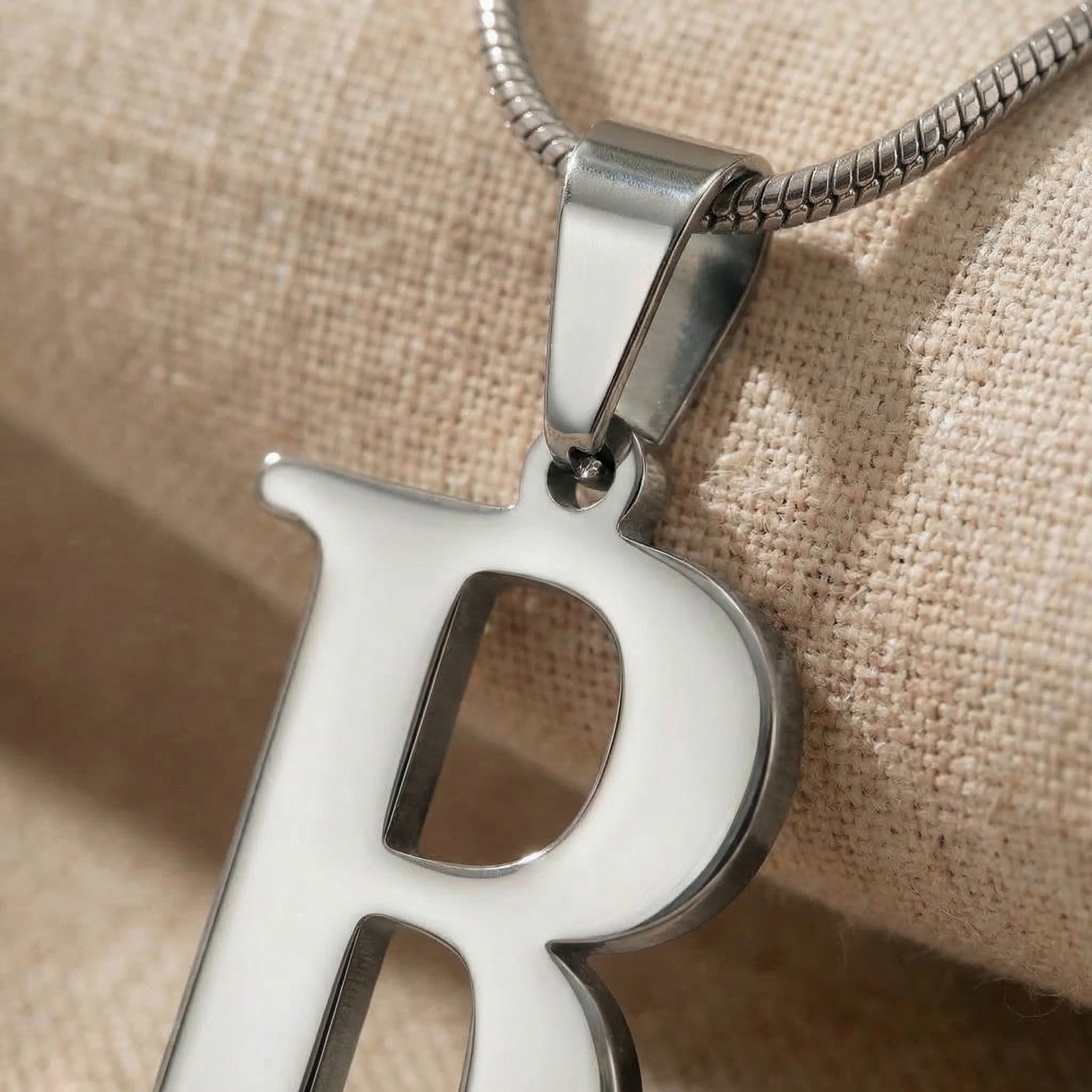 Close-up of Initial Necklace in silver with letter pendant, personalised jewellery detail