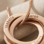 Close-up of Interlinked Love Ring Necklace showing engraved detail on interlocking rings