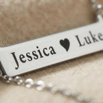 Close-up of Jess Bar Necklace showing engraved name and fine polished detail on bar pendant