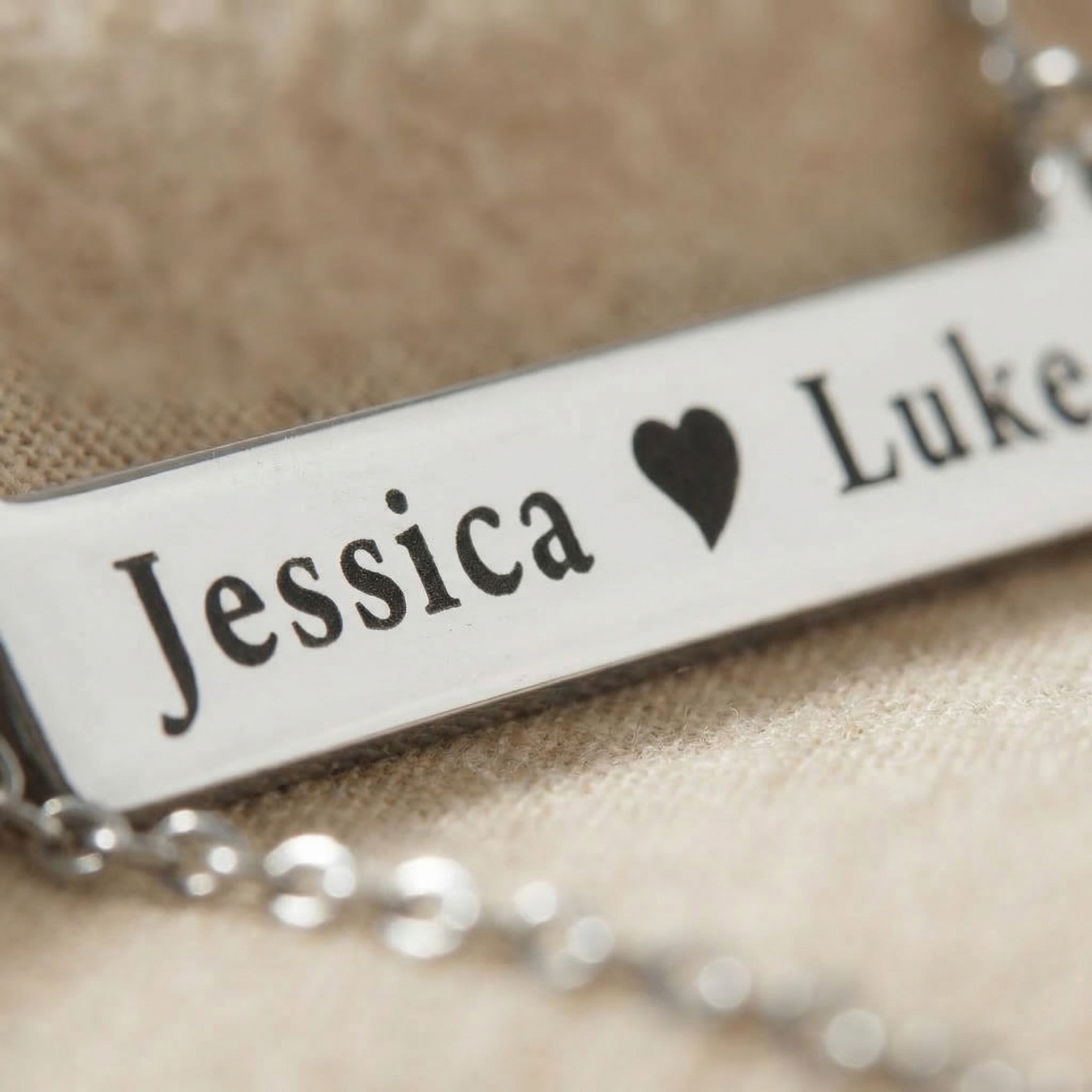 Close-up of Jess Bar Necklace showing engraved name and fine polished detail on bar pendant