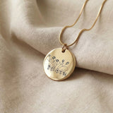 Gold kids drawing necklace with custom engraved artwork displayed on neutral background