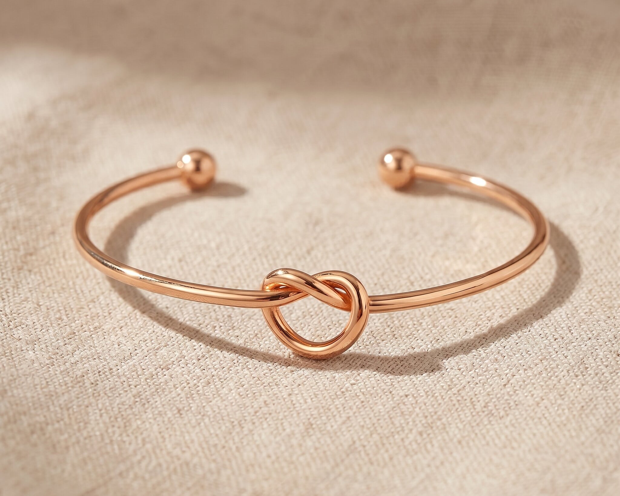Knot bangle in rose gold with symbolic knot design, elegant meaningful jewellery keepsake gift