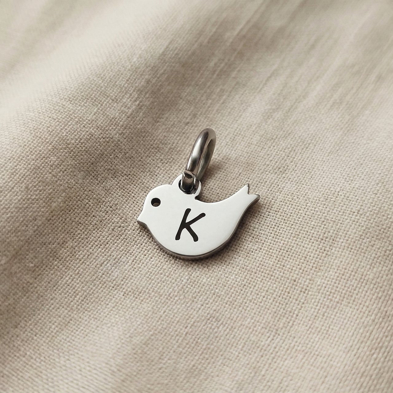 Personalized little bird charm for keyring with engraved initial symbolizing freedom, hope, and remembrance