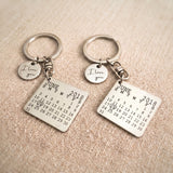 Custom matching calendar keyrings featuring an engraved milestone date and personalised disc charm for couples and loved ones.