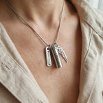 Woman wearing Memory Cremation Necklace with engraved bar pendant, memorial jewellery lifestyle image
