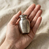 Hand holding Mini Personalised Keepsake Urn, small memorial urn for ashes keepsake