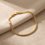 Moments charm bracelet in gold with interchangeable charm design, elegant keepsake jewellery