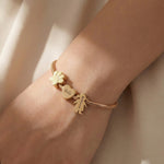 Woman wearing moments charm bracelet with personalised charms, everyday jewellery style