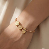 Woman wearing moments charm bracelet with personalised charms, everyday jewellery style