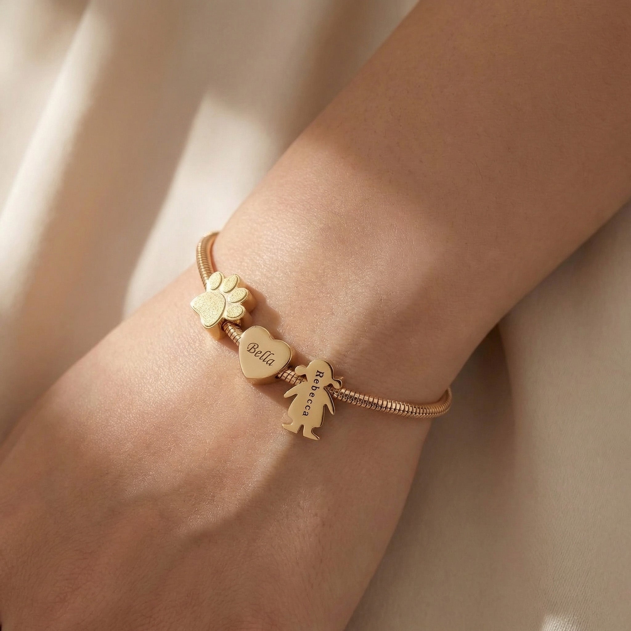 Woman wearing moments charm bracelet with personalised charms, everyday jewellery style