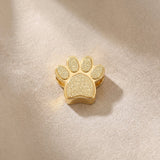 Gold paw print charm for Moments Bracelet celebrating pet lovers and meaningful animal companionship