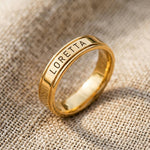 Gold personalised band ring with engraved name detail, classic custom jewelry hero product shot