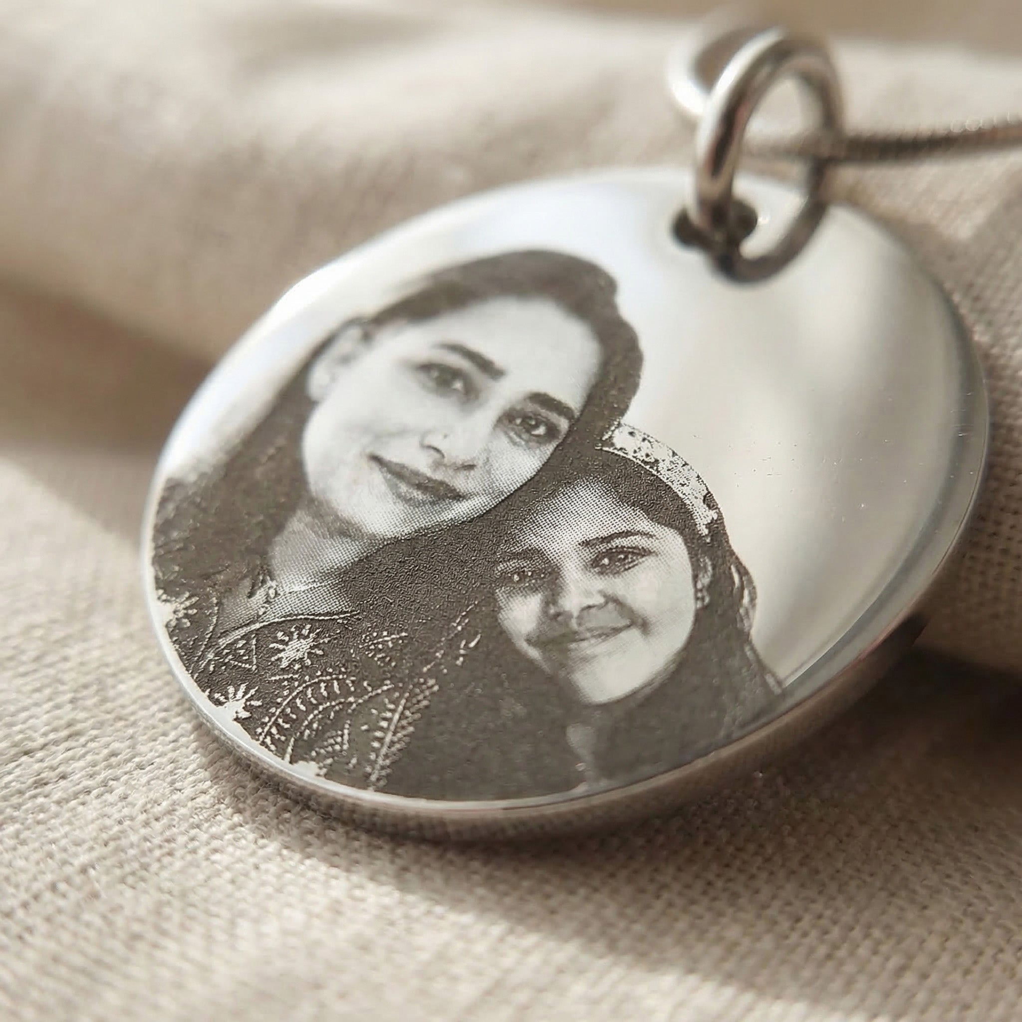 Close-up of Personalised Disc Pendant with custom photo engraving showing fine detail and finish
