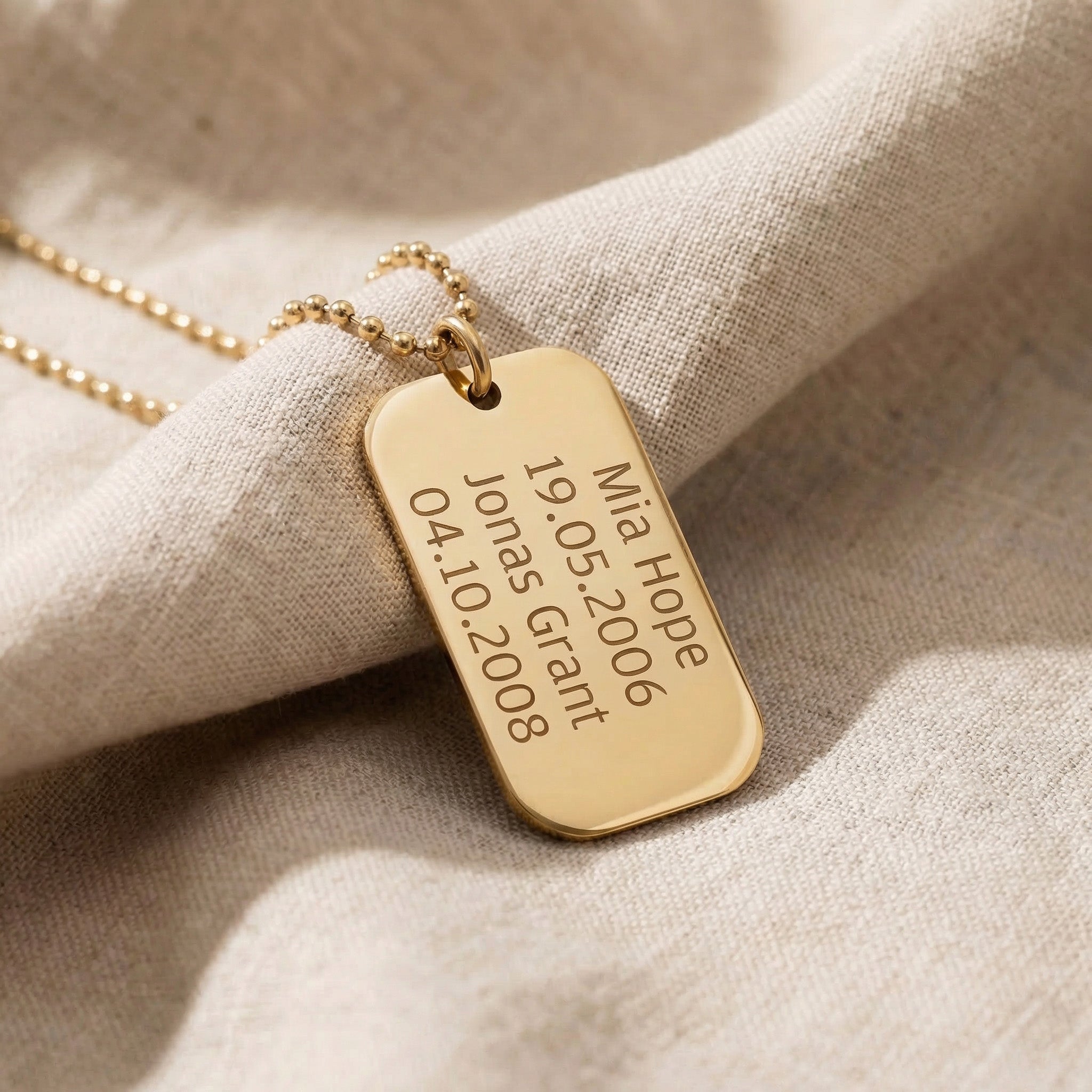 Personalised dog tag necklace in gold with engraved message, classic custom jewelry piece
