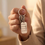 Hand holding personalised dog tag keyring with engraved message, everyday keepsake use