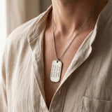 Man wearing personalised dog tag necklace with engraved message, meaningful jewelry lifestyle image