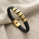 Personalised black leather bracelet with multiple engraved name charms showing customisation option