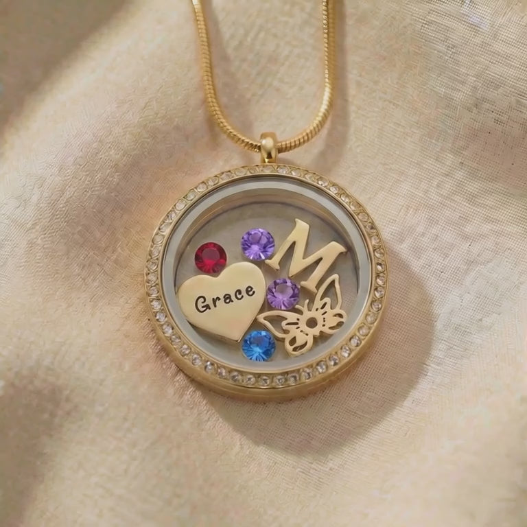 Video showing dream locket necklace with interchangeable inserts and polished finish