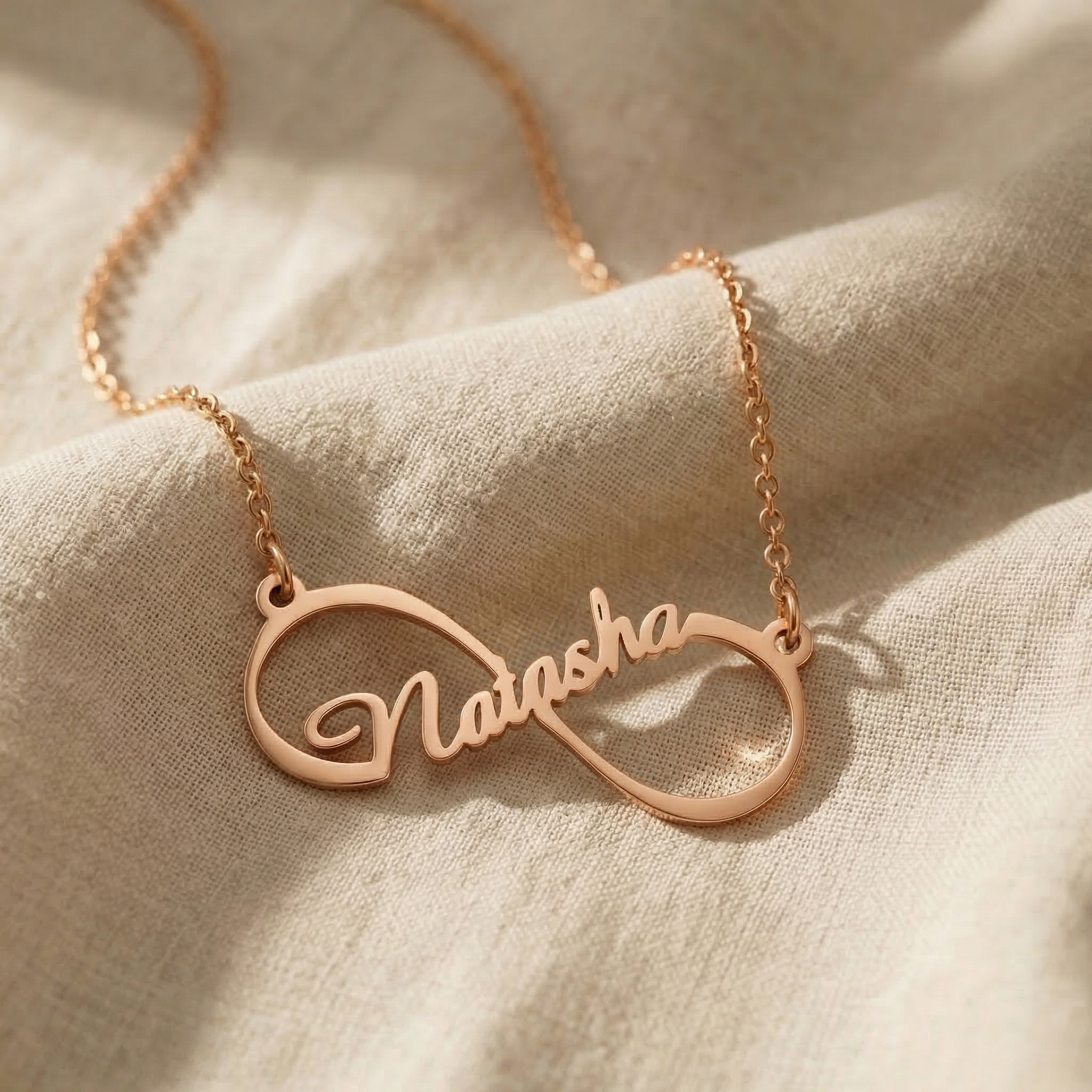Single infinity name necklace in rose gold with personalised name detaill