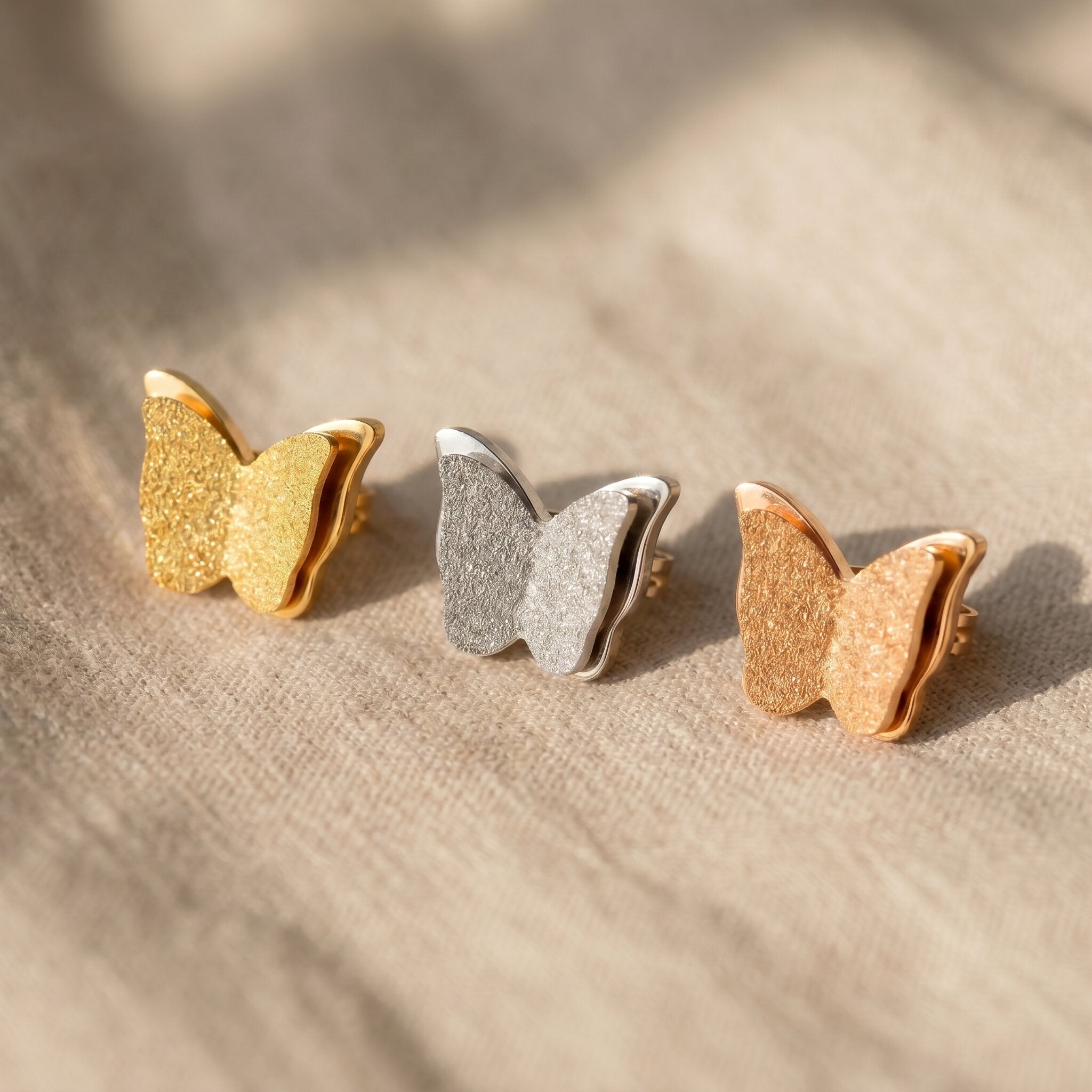 Sparkling butterfly earrings tone comparison showing gold, silver and rose gold elegant jewellery options