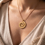 Woman wearing swirl of time necklace, meaningful jewellery symbolising life journey and precious memories
