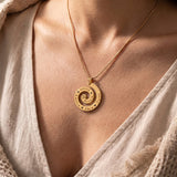 Woman wearing swirl of time necklace, meaningful jewellery symbolising life journey and precious memories