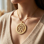 Tree of life necklace worn layered on neckline, symbolic and elegant design