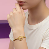 Gold Tree of Life bracelet by Belle Fever styled on wrist, symbol of growth jewelry.